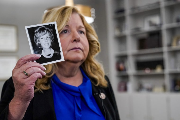 Image: Nassau County District Attorney Anne Donnelly holds a photo of Diane Cusick during an interview on June 22, 2022, in Mineola, N.Y.