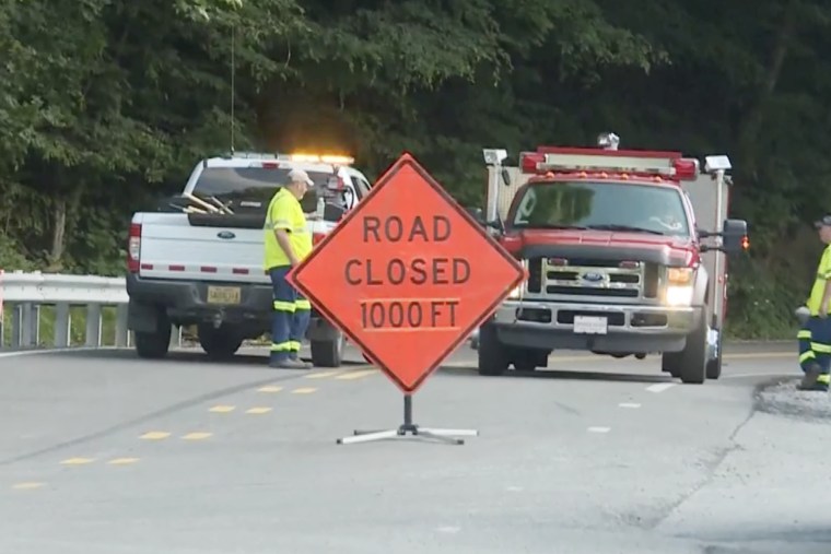 Emergency crew close the road near where a helicopter crashed near Route 17 along Blair Mountain, W.Va on Wednesday.