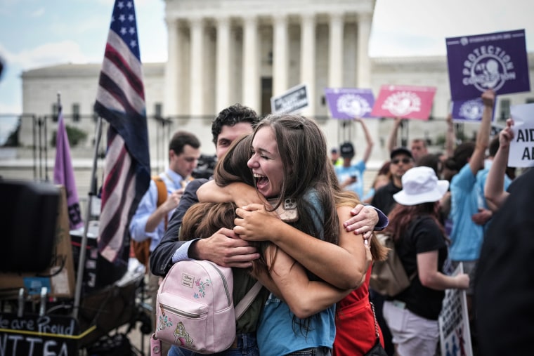 Anti-abortion advocates celebrate Friday outside the Supreme Court.