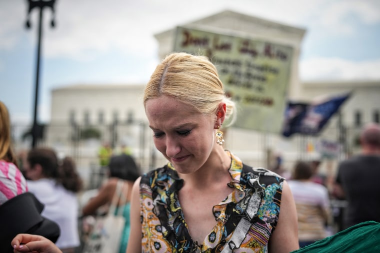 An abortion rights advocate cries outside the Supreme Court on Friday.
