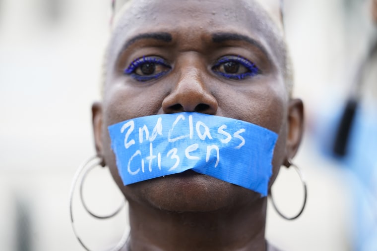 An abortion rights activist wears tape reading "2nd Class Citizen"