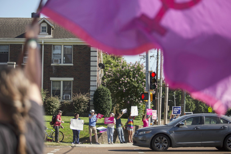 Abortion rights demonstrators protest along Poplar Ave. in Memphis, Tenn. on June 24, 2022 in response to the news of the Supreme Court decision that will overturn the constitutional protections around abortion access.