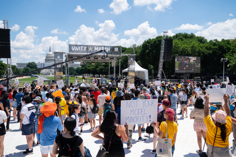 Demonstrators listen to speakers during the Unity March rally