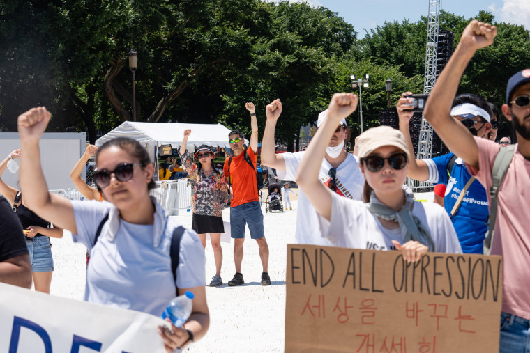 Demonstrators raise their fists during the Unity March rally