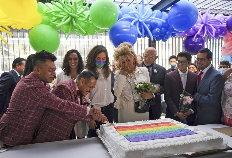 same-sex couples cut a cake during a mass wedding ceremony in Mexico City