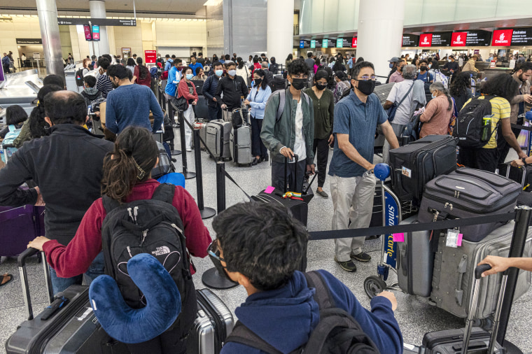 Travelers wait to check in at San Francisco International Airport