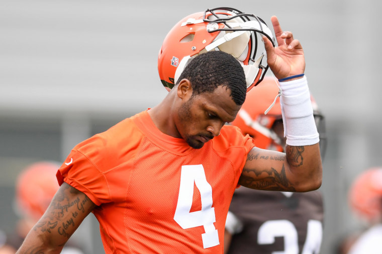Deshaun Watson of the Cleveland Browns takes off his helmet as he warms up during the Cleveland Browns mandatory minicamp on June 14, 2022, in Berea, Ohio.