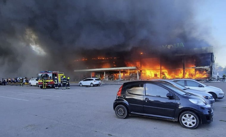 Firefighters work to extinguish a fire at a shopping center