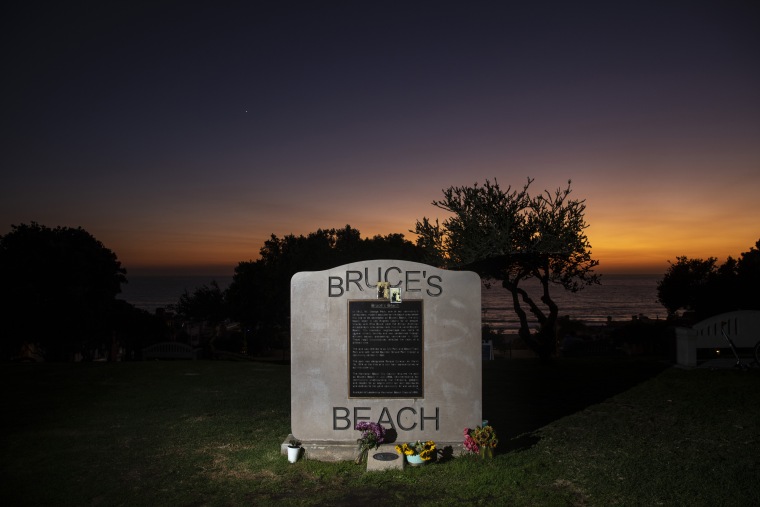 Image: The sun sets behind a plaque memorializing a park adjacent to Bruce's Beach, in Manhattan Beach, Calif., on Sept. 30, 2021.