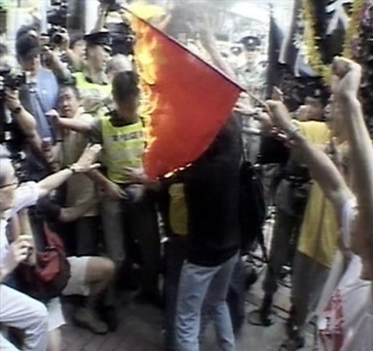 Demonstrators in Hong Kong burn the Chinese flag to protest against the proposed Article 23 legislation in July 2003. 