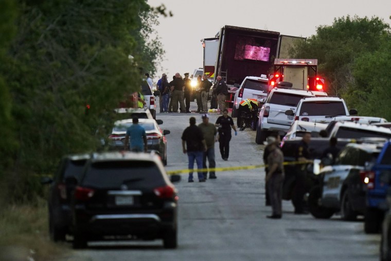 Police and other first responders work the scene where officials say dozens of people have been found dead and multiple others were taken to hospitals with heat-related illnesses after a tractor-trailer containing suspected migrants was found on June 27, 2022, in San Antonio. Officials said two men were indicted Wednesday, July 20 in the case.