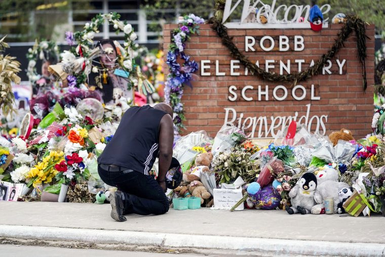 A man pays his respects at a memorial outside Robb Elementary School on June 9, 2022, in Uvalde, Texas.