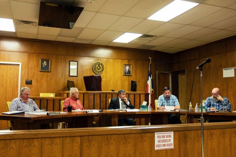 Loving County commissioners, including Ysidro Renteria, second from left, and County Judge Skeet Jones, center, listen to County Commissioner Raymond King read a resolution from the appraisal district's board of directors to remove Renteria on June 13.