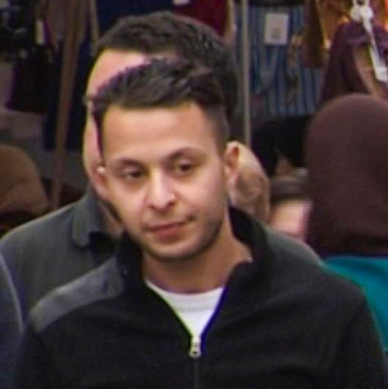 Salah Abdeslam, left, walks through the Molenbeek market in Brussels on April 13, 2016.