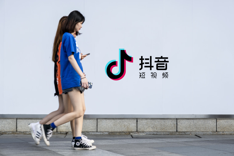 Image: Pedestrians walk past an advertisement for Tik Tok on June 16, 2019 in Guangzhouo, China.