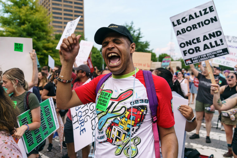 People participate in a call and response to protest the Supreme Court's decision in the Dobbs v Jackson Women's Health case on June 24, 2022 in Atlanta.