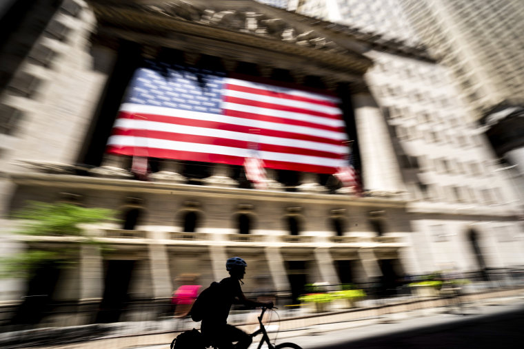 Image: A person bikes past the New York Stock Exchange on June 29, 2022 in New York.