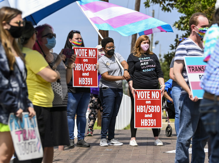 Opponents of several bills targeting transgender youth attend a rally at the Alabama State House in Montgomery, on March 30, 2021.