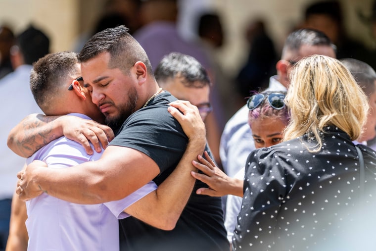 People grieve and embrace outside of Amerie Jo Garza's, 10, funeral service. Wakes and funerals for the 21 victims are scheduled throughout the week.