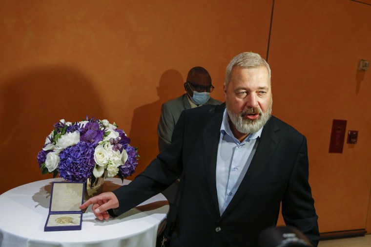 El Premio Nobel de la Paz Dmitry Muratov, redactor jefe del influyente periódico ruso Novaya Gazeta, posa para una foto junto a su medalla de oro de 23 quilates antes de ser subastada en el Times Center, el lunes 20 de junio de 2022, en Nueva York.