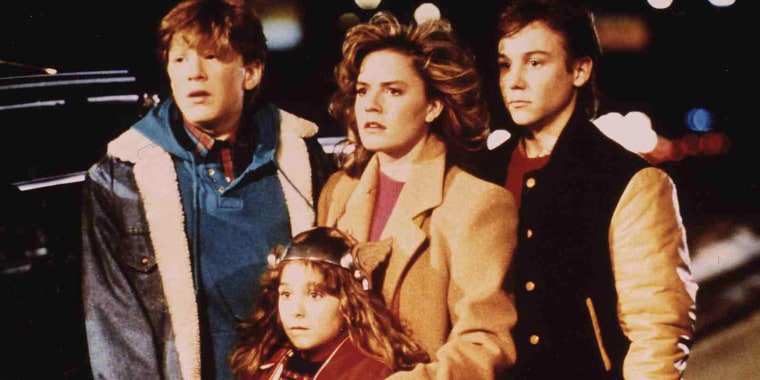 Anthony Rapp (Daryl), Maia Brewton (Sara), Elisabeth Shue (Chris) and Keith Coogan (Brad) in a scene from "Adventures In Babysitting."