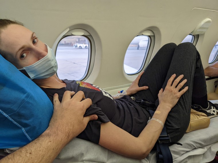 Andrea Prudente, being comforted during her medical emergency flight.