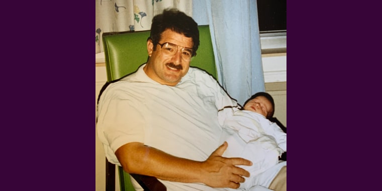 A photo of my late father holding me as a baby.
