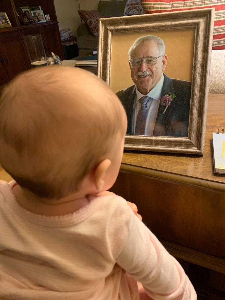 My daughter staring at a photo of my dad.
