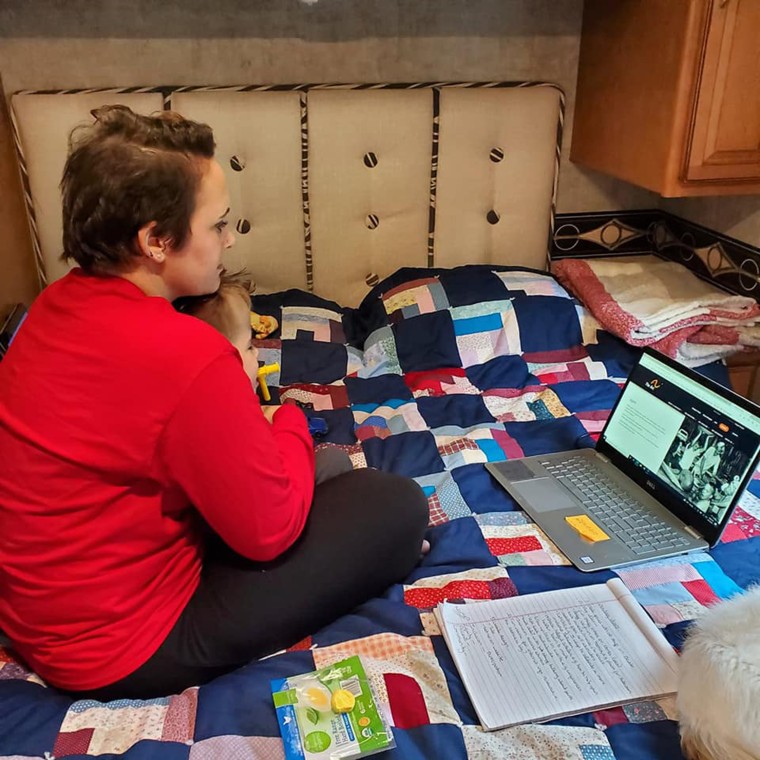 Whitney Stohr finds time to work during Malachi's first camping trip.