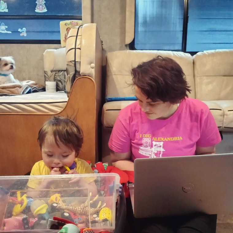 Whitney Stohr is pictured working and living with her family in an RV during home accessibility renovations in 2021.