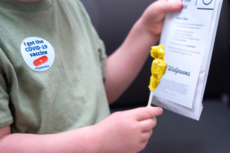Fletcher Pack, 3, holds a lollipop after receiving a COVID-19 vaccination on June 20 in Lexington, S.C. (AP Photo/Sean Rayford)