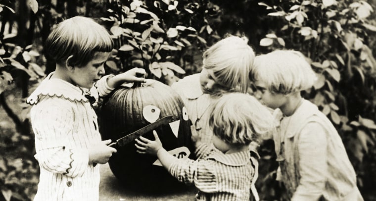 Children Decorating Pumpkin for Halloween