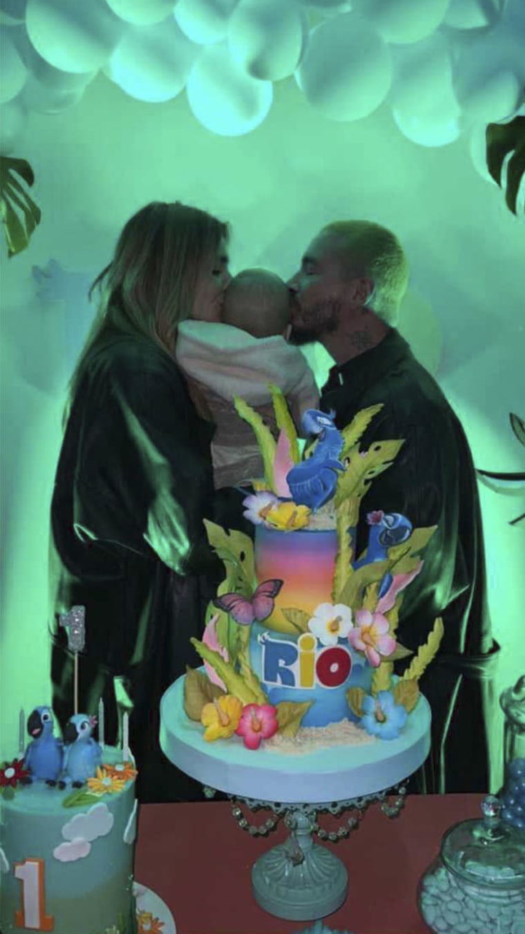 J Balvin y Valentina Ferrer abrazan a su hijo Río, junto al pastel de cumpleaños de su bebé.