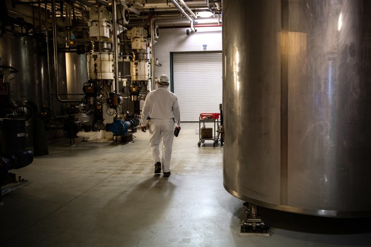 An employee makes his way through machines at Mars Chocolate of North America factory in Elizabethtown, Pennsylvania in March 2019.