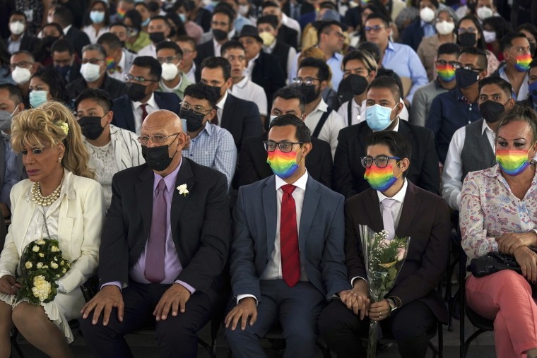 Couples of the same sex attend a mass wedding ceremony organized by city authorities as part of the LGBTQ pride month celebrations, in Mexico City, Friday, June 24, 2022. 