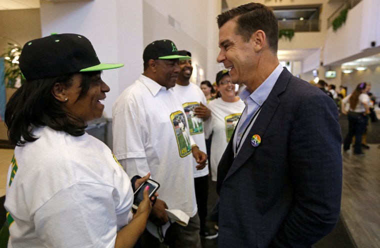 Billy Bean, right, MLB's ambassador for inclusion, meets with Carol Williams, sister of Glenn Burke, before the baseball game between the San Diego Padres and the Oakland Athletics on June 17, 2015, in Oakland, California.
