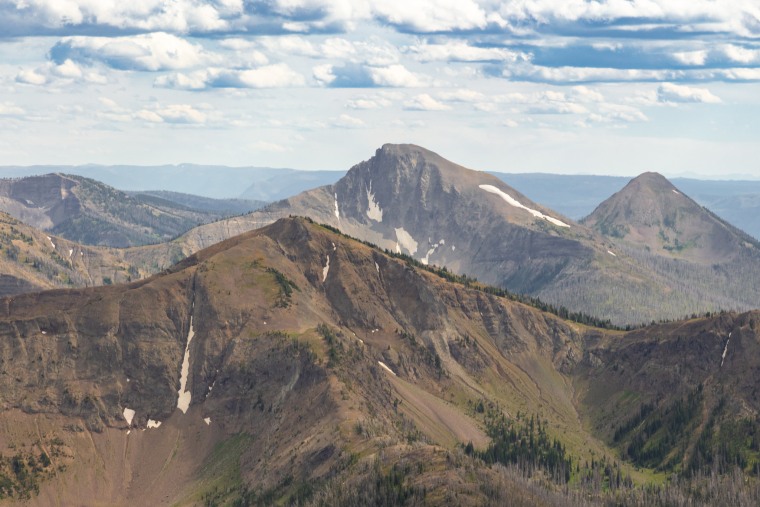 First Peoples Mountain (center) rises between Top Notch Peak (foreground) and Mt. Stevenson (back right) seen from Avalanche Peak in Yellowstone National Park.