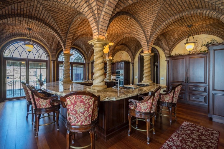 The kitchen has some majestic touches, including elaborate columns.