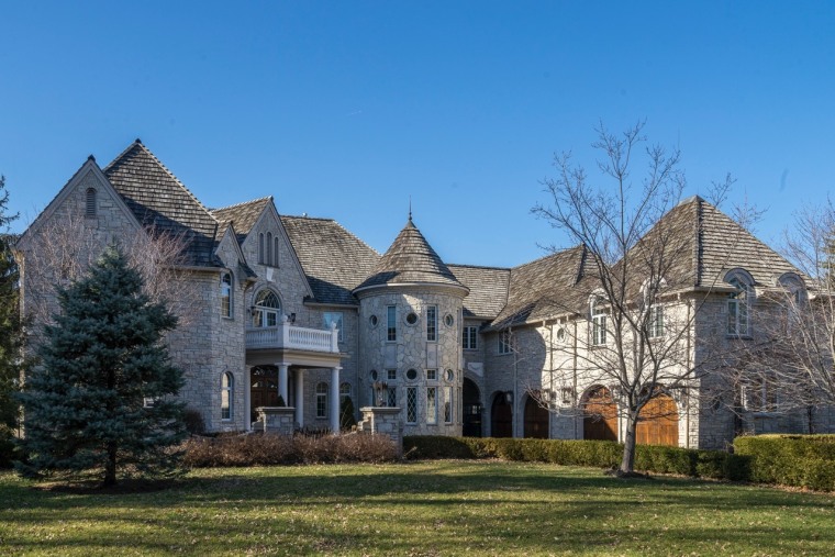 The estate features a turret and several garages.