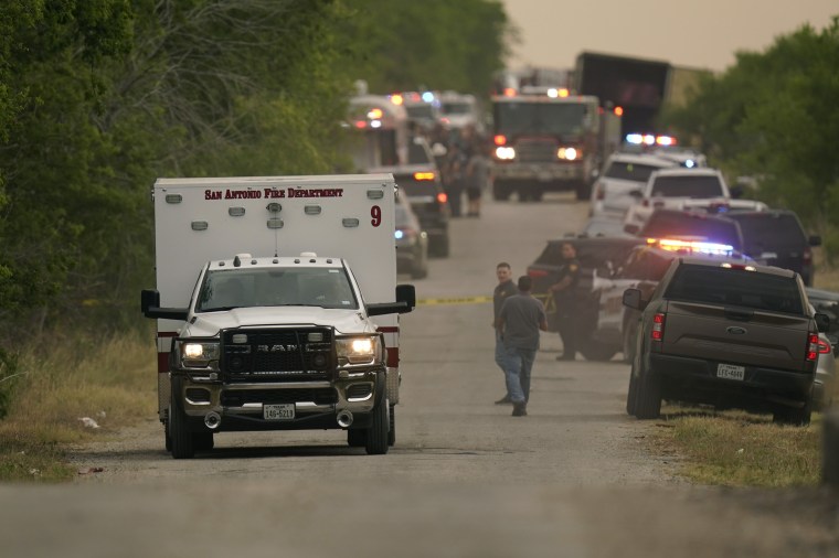 An ambulance leaves the scene where police said dozens of people were found dead in a semitrailer in a remote area in southwestern San Antonio, Monday, June 27, 2022.