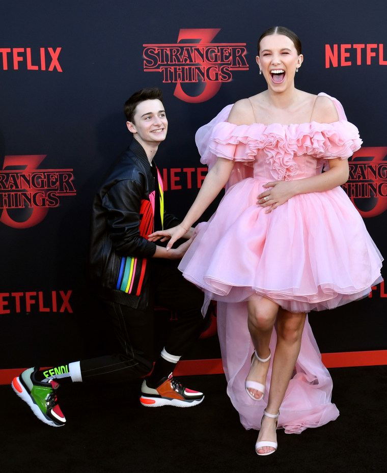 Noah Schnapp (L) and Millie Bobby Brown attend the premiere of Netflix's "Stranger Things" Season 3.