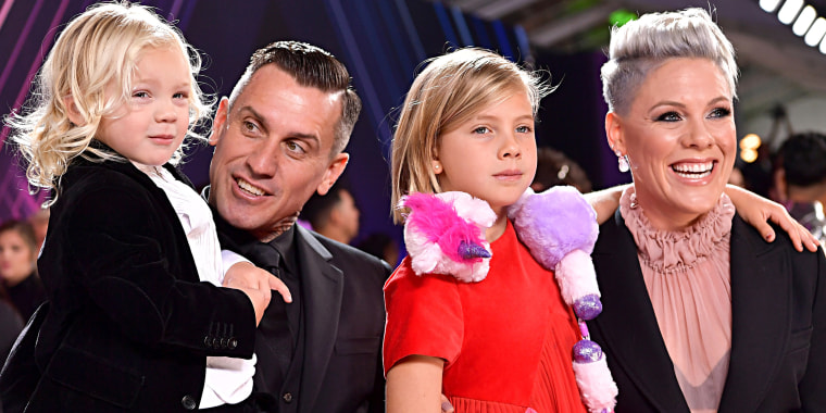 Carey Hart (second from left) has two children,  Jameson (far left) and Willow (third from left) with wife and singer Pink (far right).