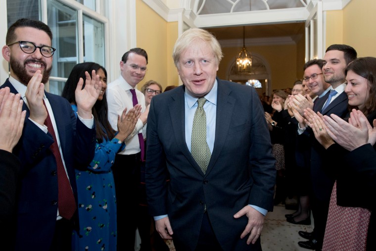 Britain's Prime Minister and Conservative Party leader Boris Johnson is greeted by staff as he arrives back at 10 Downing Street in central London on Dec. 13, 2019, following an audience with Britain's Queen Elizabeth II at Buckingham Palace, where she invited him to become Prime Minister and form a new government.