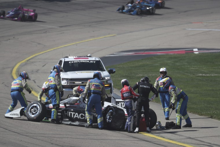 Josef Newgarden is helped from his car after he crashed Sunday during the Hy-Vee Salute to Farmers 300 at Iowa Speedway in Newton. 