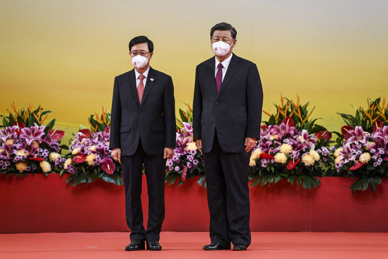 China's President Xi Jinping, right, stands with Hong Kong's new Chief Executive John Lee after Lee was sworn in as the city's new leader, during a ceremony to inaugurate the city's new government in Hong Kong on July 1, 2022, on the 25th anniversary of the city's handover from Britain to China.