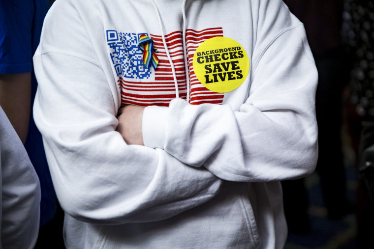 Image: An attendee wears a "Background Checks Saves Lives" sticker during the unveiling of legislation to expand background checks for sales of firearms on Jan. 8, 2019 in Washington, D.C.