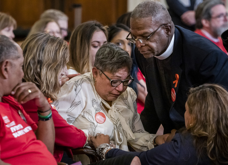 Rev. Sharon Risher, center, whose mother, Ethel Lance was killed in the shooting at the Emanuel AME Church shooting in Charleston, S.C., is comforted during a House Democratic forum urging the Senate to vote on a bill that would expand background checks for gun purchases on Sept. 10, 2019 in Washington, D.C.