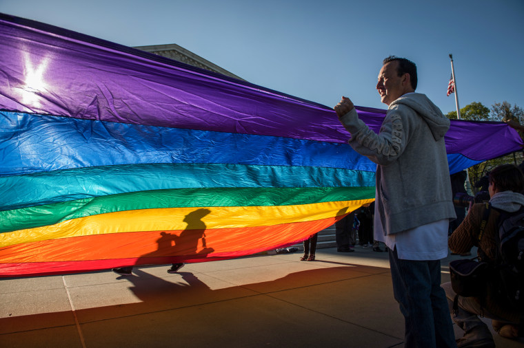 Demonstrators rally outside the Supreme Court before oral arguments on same sex marriage in Washington, D.C., on April 28, 2015.