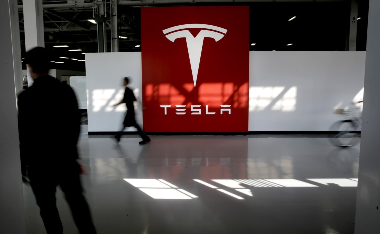 A huge logo greets workers heading to the assembly line at Tesla Motors, California's only full-scale auto manufacturing plant, as seen on Thurs. Feb. 19, 2015, in Fremont, Calif.