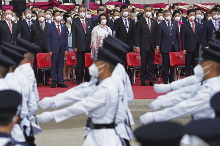 Officials and guests attend a flag raising ceremony at the Golden Bauhinia Square in Hong Kong on Friday to mark the 25th anniversary of the former British colony's return to Chinese rule.
